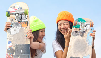 Two girls skaters laughing